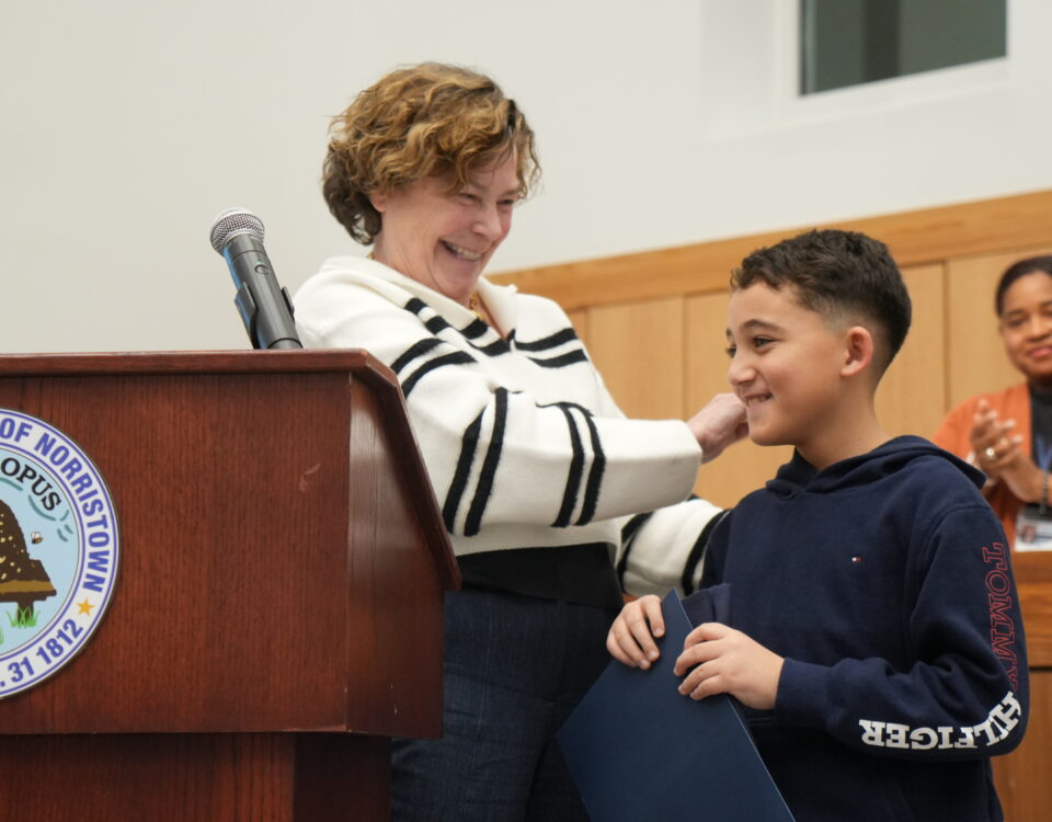 Grayson, a 2025 Steward for Tomorrow Youth Awardee, receives recognition at a Norristown town meeting in March 2026.