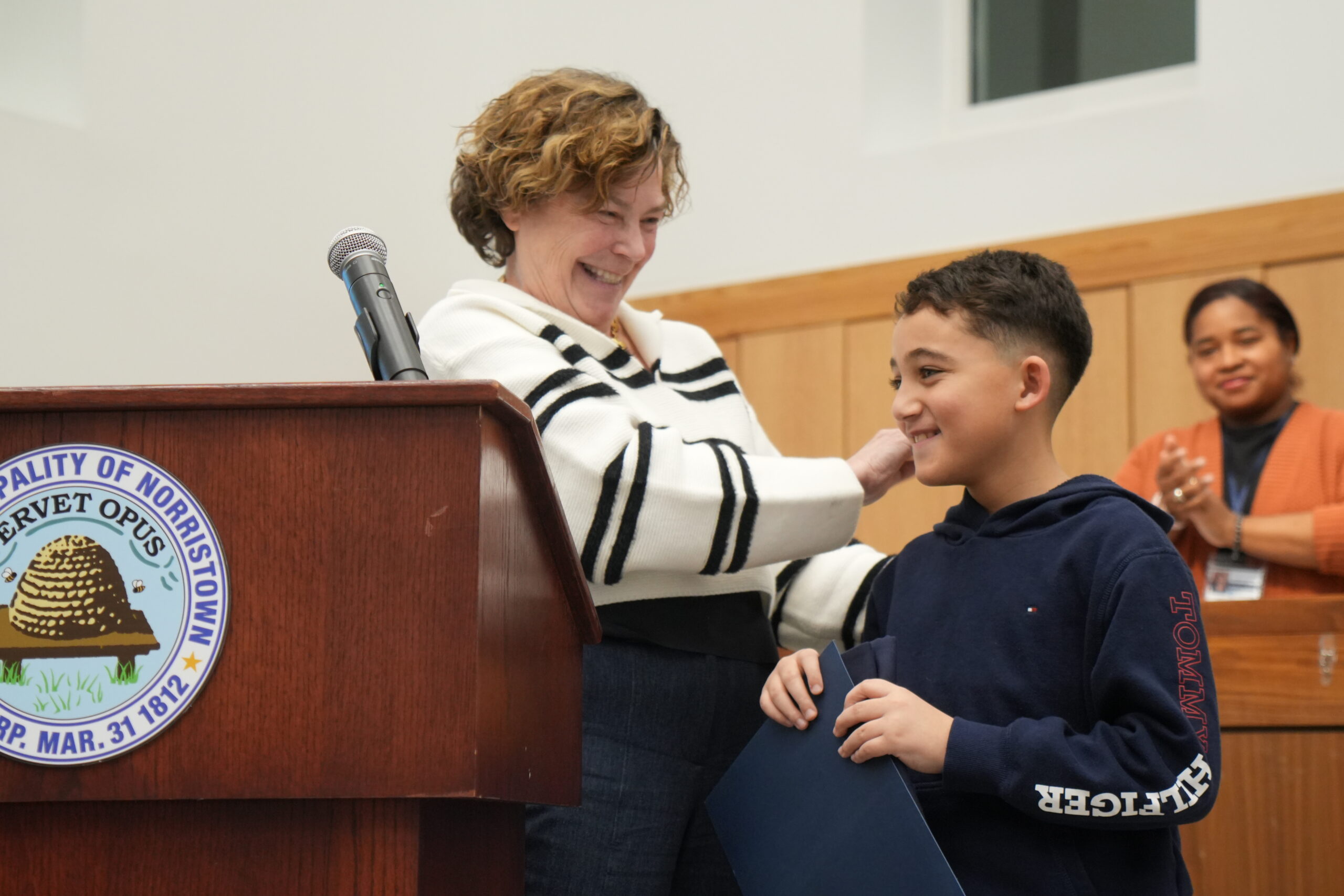 Grayson, a 2025 Steward for Tomorrow Youth Awardee, receives recognition at a Norristown town meeting in March 2026.